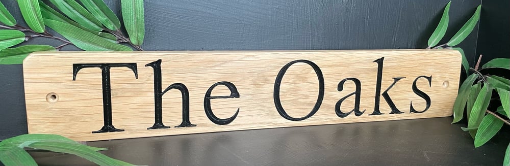 CNC personalisation of hand crafted oak house sign